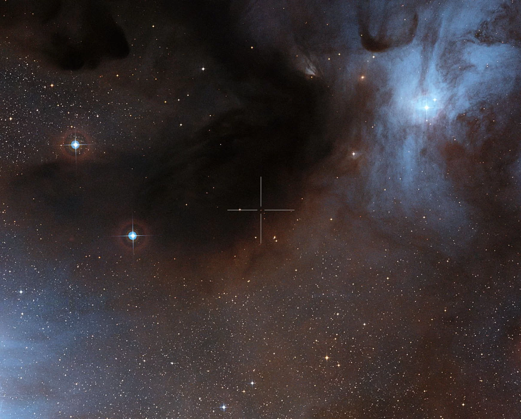 Na tym obrazie widać brązowego karła ISO-Oph 102 lub RHO-Oph 102 w strefie powstawania gwiazd Rho Opiuchi; jego umiejscowienie zostało zaznaczone przy pomocy krzyża. Obraz światła widzialnego powstał ze zdjęć stanowiących część zbioru Digitalized Sky Survey 2. Zdjęcie udostępniono 30.11.2012.