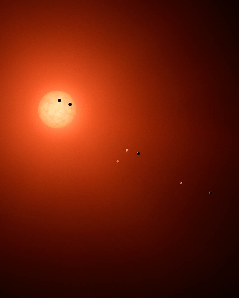 Wizja artystyczna jak mógłby wyglądać układ TRAPPIST-1 widziany z Ziemi dzięki niespotykanie potężnemu teleskopowi.